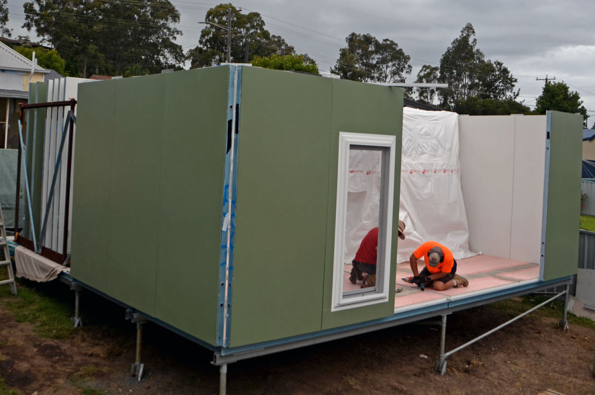 A MAAP house being built on site, individual panels are connected together to create the building floor walls and roof